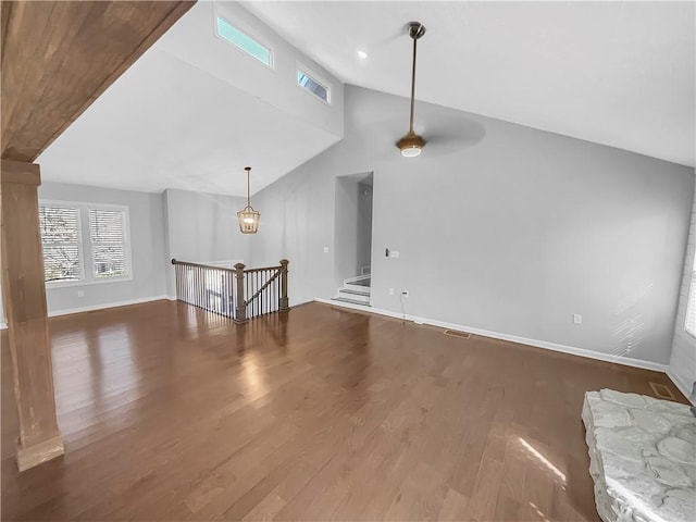 unfurnished living room featuring baseboards, visible vents, wood finished floors, high vaulted ceiling, and recessed lighting