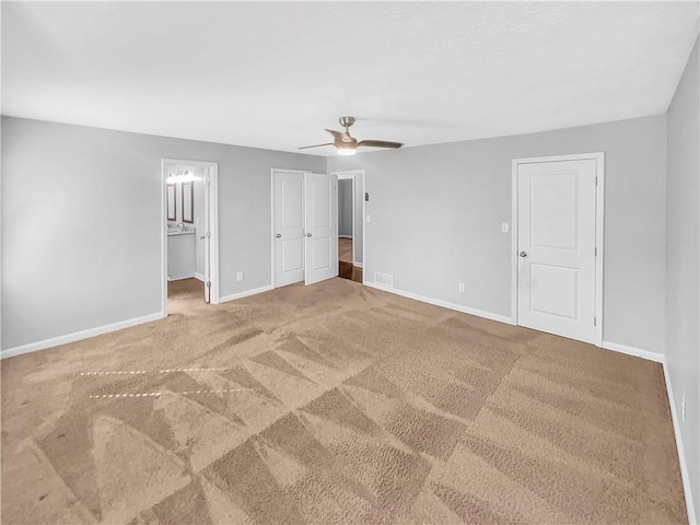 unfurnished bedroom featuring carpet, visible vents, and baseboards