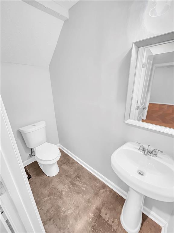 bathroom with toilet and baseboards