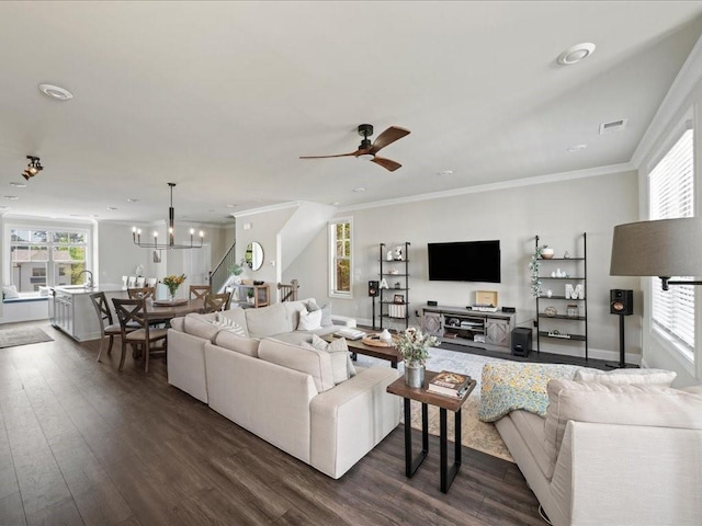 3862 Firewood Ln Unit 110, Suwanee, GA 30024 - living room featuring healthy amount of natural light, dark wood finished floors, ornamental molding, ceiling fan, and a chandelier