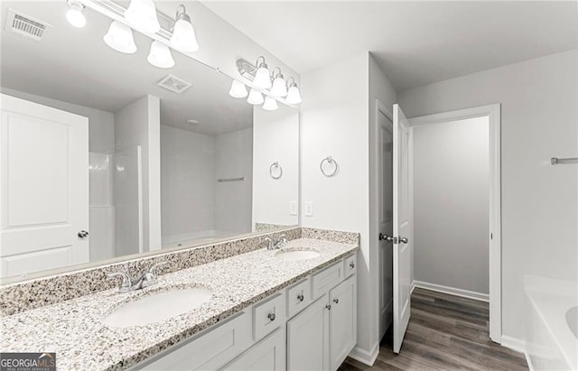 bathroom featuring wood-type flooring, a bathtub, and vanity