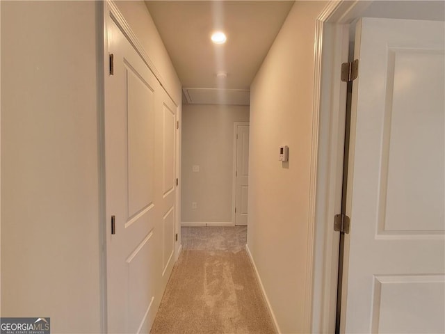 hallway featuring light carpet