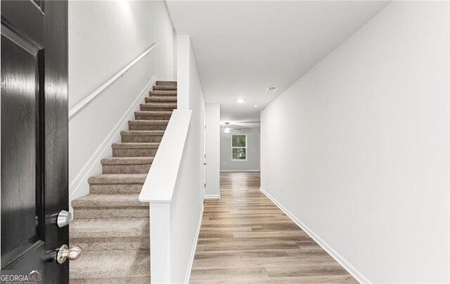 spare room featuring wood-type flooring and ceiling fan