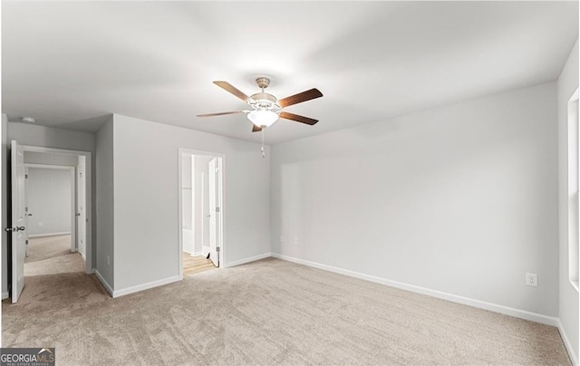 unfurnished bedroom with light carpet, ceiling fan, and ensuite bathroom