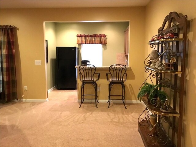 living room featuring ceiling fan and light colored carpet