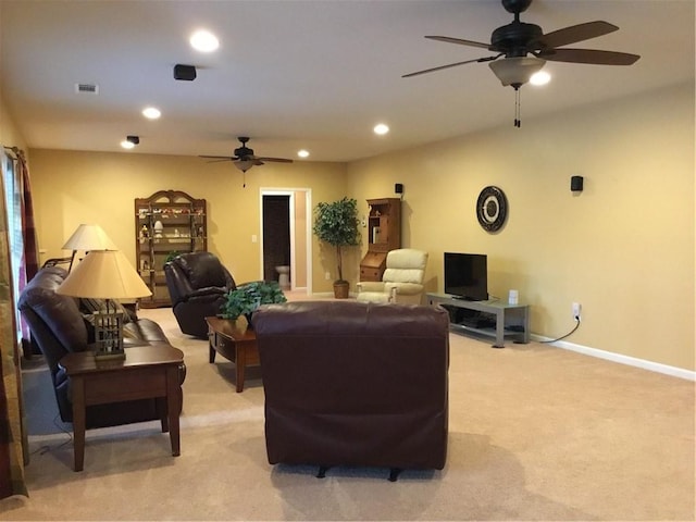 carpeted living room with ceiling fan