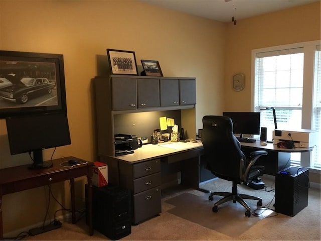 home office featuring a wealth of natural light and light carpet