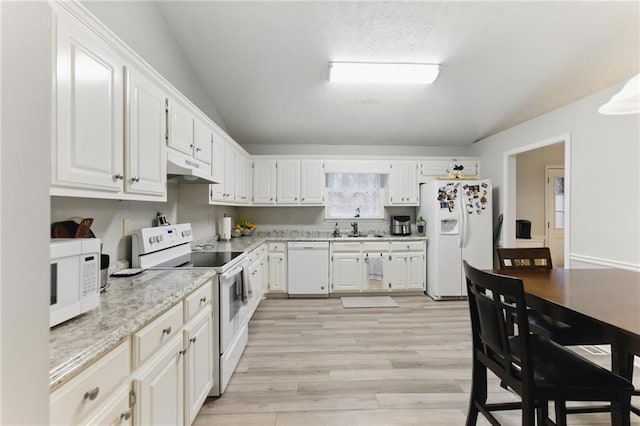 kitchen featuring under cabinet range hood, light wood-style floors, white appliances, white cabinetry, and a sink