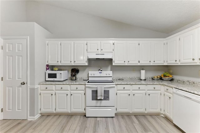 kitchen featuring under cabinet range hood, white cabinets, white appliances, and lofted ceiling