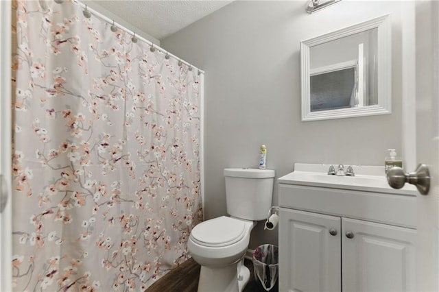 full bath with a shower with curtain, toilet, vanity, and a textured ceiling