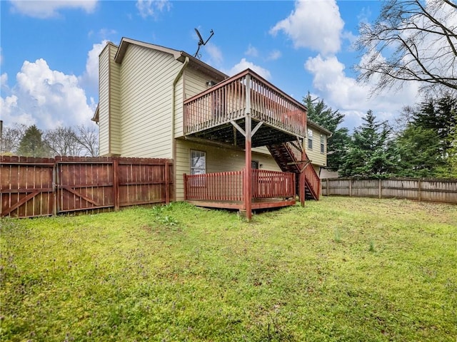 rear view of property featuring stairway, a lawn, a chimney, a fenced backyard, and a deck