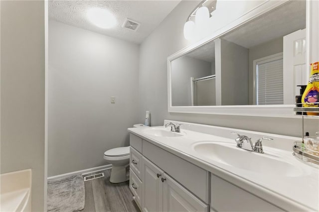 bathroom with a sink, visible vents, and a shower stall