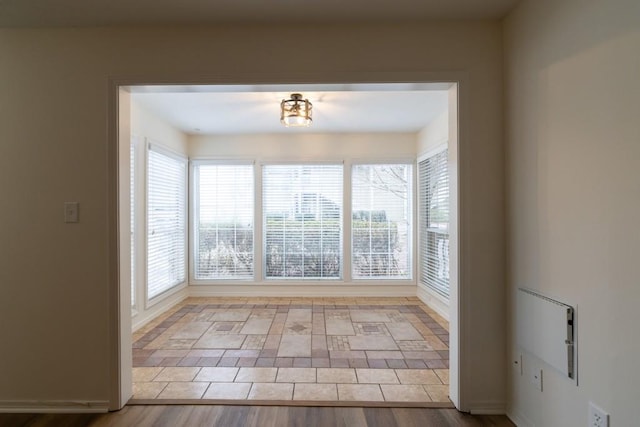 empty room featuring a wealth of natural light and light wood-type flooring