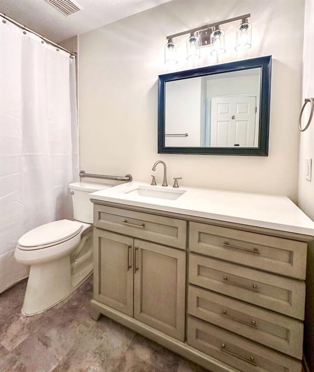 bathroom featuring vanity, concrete floors, a textured ceiling, and toilet