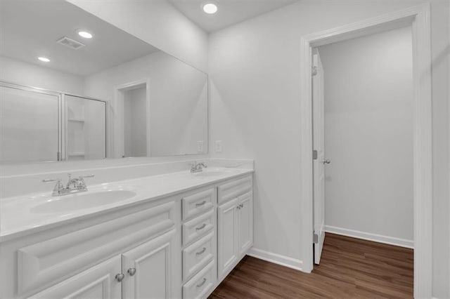 full bath with recessed lighting, baseboards, a sink, and wood finished floors