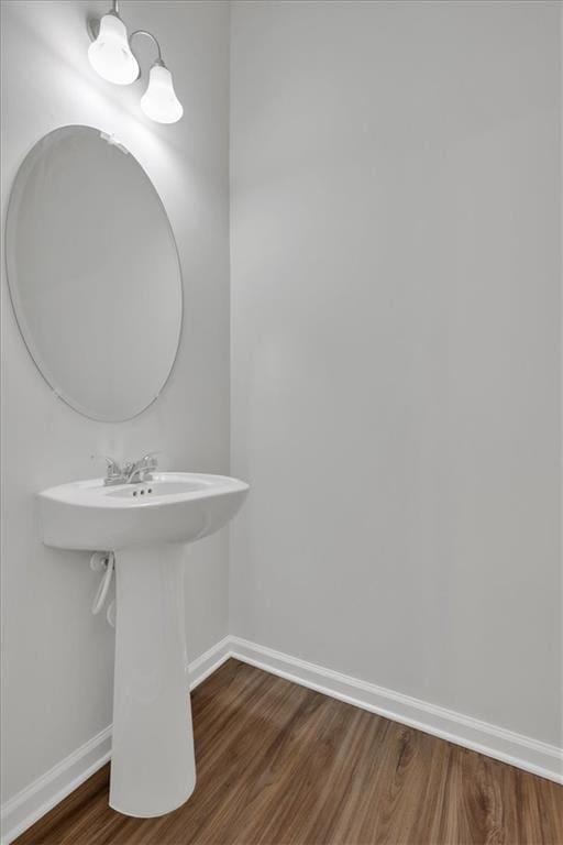 bathroom featuring baseboards and wood finished floors