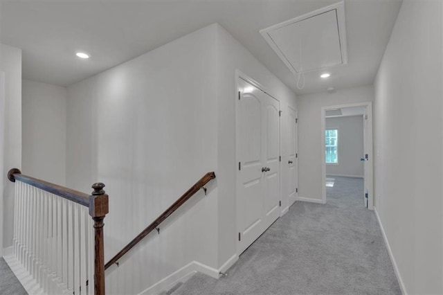 corridor featuring recessed lighting, light carpet, an upstairs landing, baseboards, and attic access