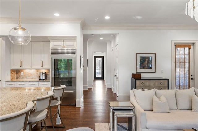 living room featuring crown molding and dark hardwood / wood-style flooring