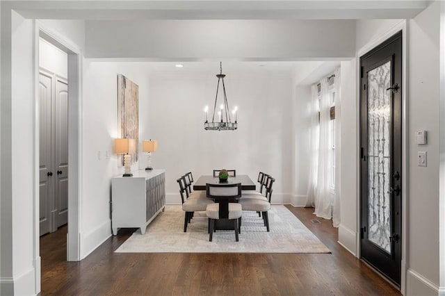 dining space featuring an inviting chandelier and hardwood / wood-style floors