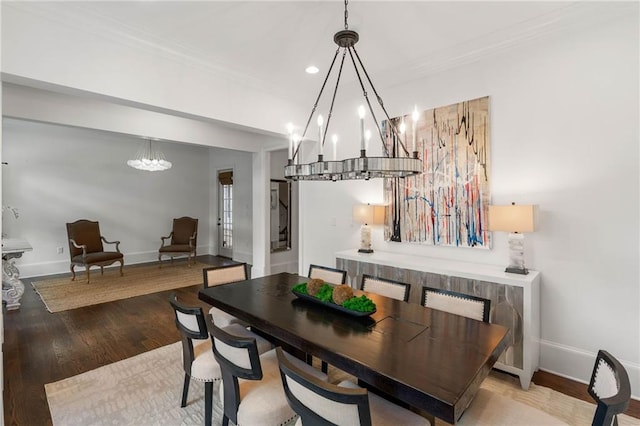 dining area with ornamental molding, an inviting chandelier, and light wood-type flooring