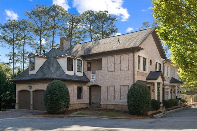 french country home featuring a garage