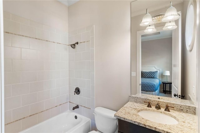 full bathroom with an inviting chandelier, vanity, tiled shower / bath combo, and toilet