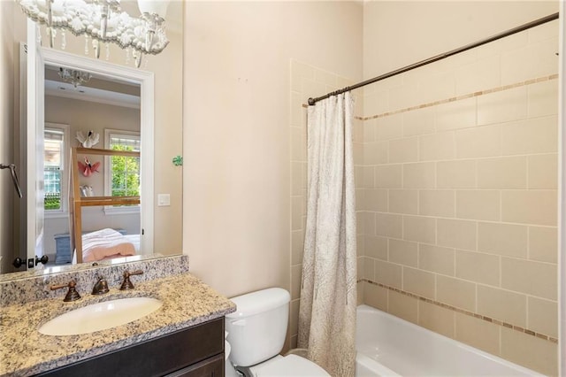 full bathroom with vanity, shower / bath combo with shower curtain, and toilet