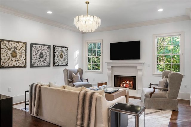 living room featuring ornamental molding, a chandelier, and dark hardwood / wood-style flooring