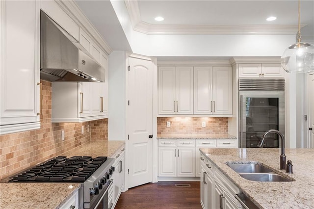 kitchen featuring sink, pendant lighting, light stone counters, high end appliances, and ventilation hood