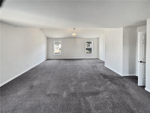 carpeted spare room with a notable chandelier