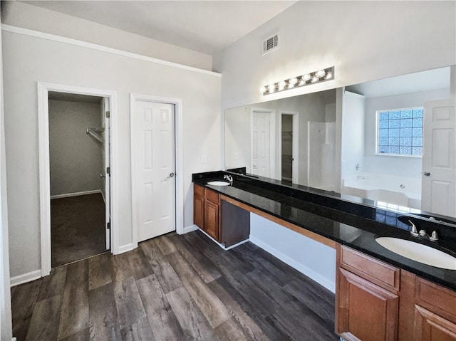 bathroom featuring vanity, a bath, and hardwood / wood-style flooring