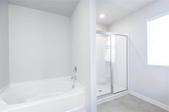 bathroom featuring separate shower and tub