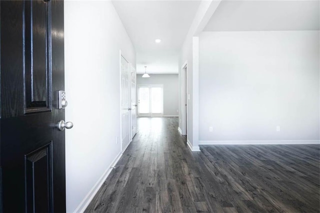 corridor featuring dark wood-type flooring