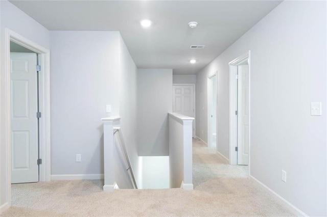 hallway featuring light carpet