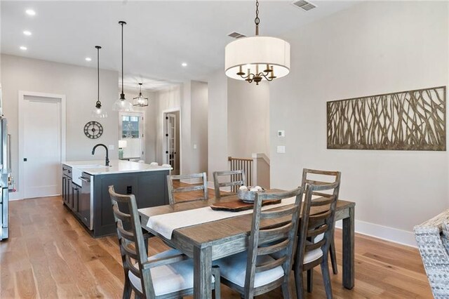 dining room with light hardwood / wood-style flooring and sink