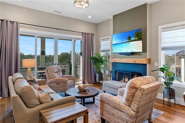 living room featuring a chandelier, hardwood / wood-style flooring, and plenty of natural light