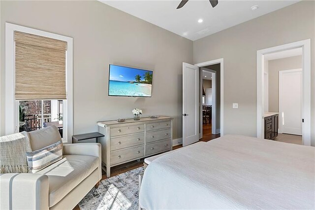 bedroom with ceiling fan, dark hardwood / wood-style flooring, and ensuite bathroom