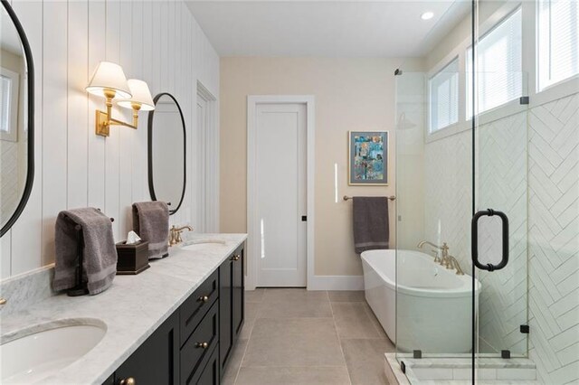 bathroom featuring vanity, tile patterned floors, wooden walls, and separate shower and tub