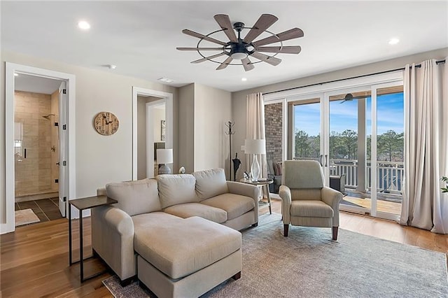 living room with recessed lighting, ceiling fan, and wood finished floors