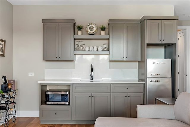 kitchen with gray cabinetry and stainless steel appliances