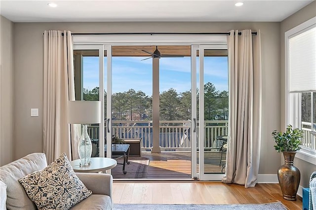 doorway to outside with recessed lighting, baseboards, and wood finished floors