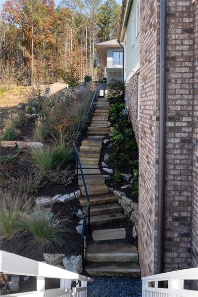 view of property exterior with brick siding and stairway