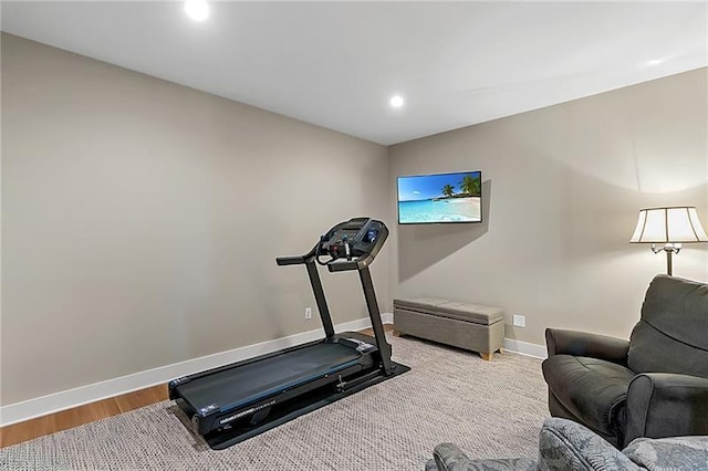 workout room with recessed lighting, wood finished floors, and baseboards