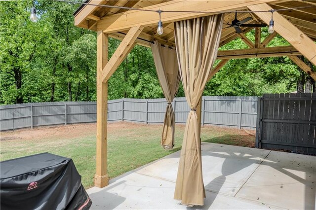 view of patio / terrace with a gazebo, a ceiling fan, and a fenced backyard