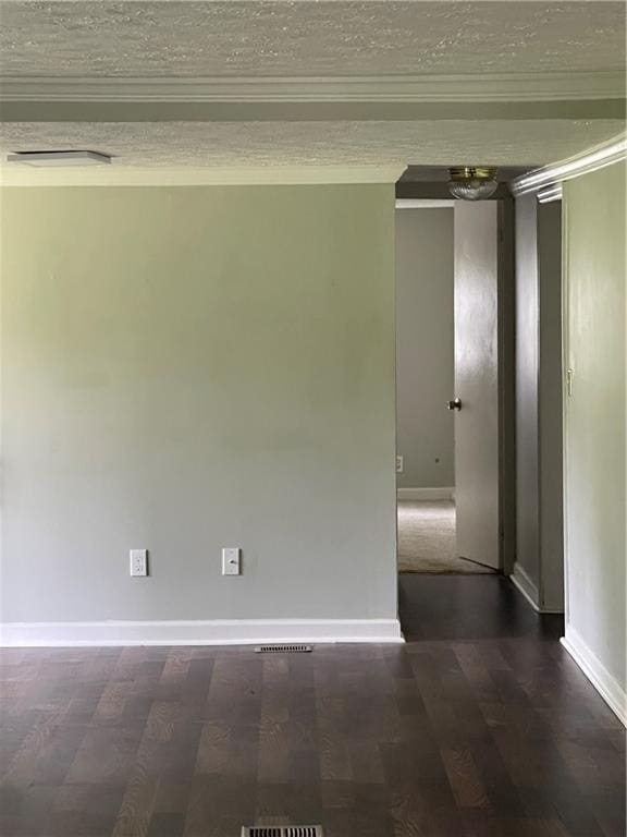 spare room with dark wood-type flooring and ornamental molding