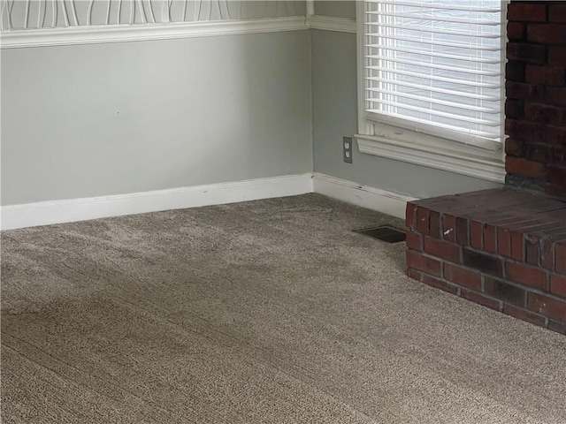 carpeted empty room with crown molding