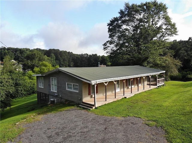 exterior space with cooling unit and a lawn