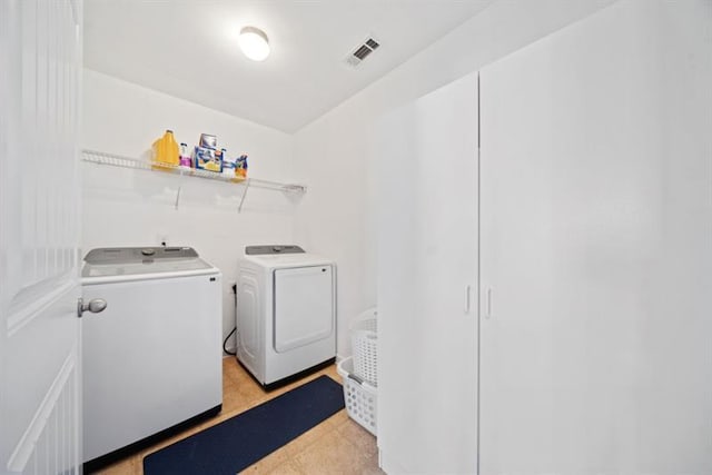 clothes washing area with washing machine and clothes dryer