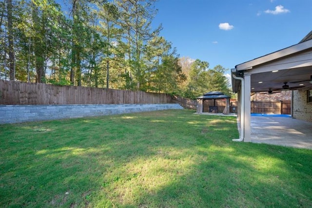 view of yard with ceiling fan, a patio area, and a gazebo