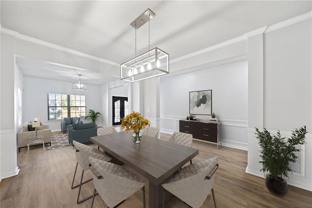 dining room featuring hardwood / wood-style flooring and crown molding